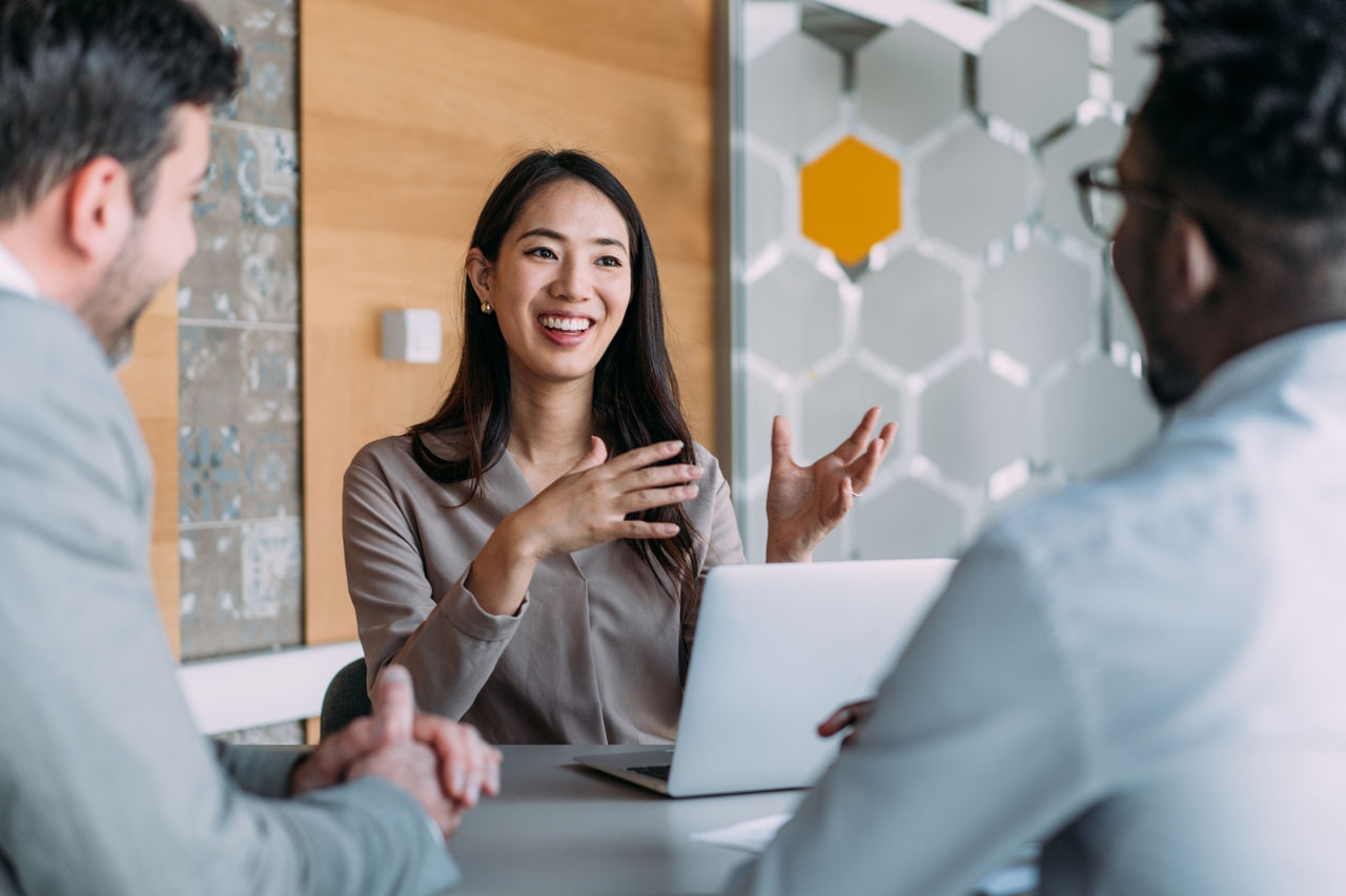 Shot of group of business persons in business meeting. Three entrepreneurs on meeting in board room. Creative business team on meeting in modern office. Female manager discussing new project with her colleagues. Company owner on a meeting with two of her employees in her office.