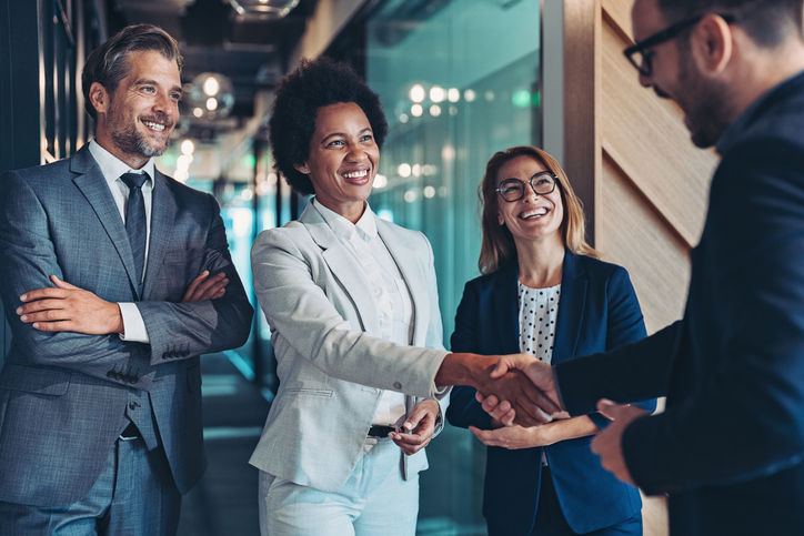 Group of business persons shaking hands in the office