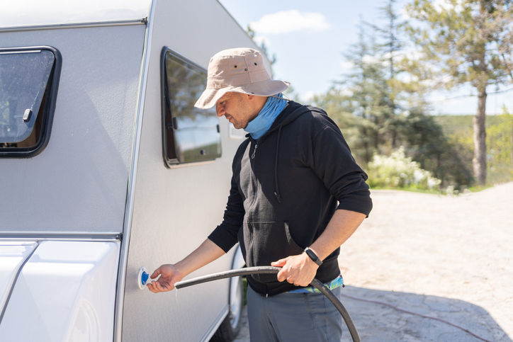 Man Filling Caravan Tank With Clean Water