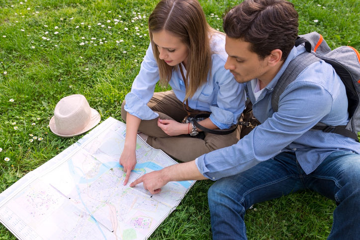 Happy couple of tourists in the park