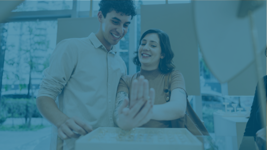 couple looking at jewelry in store with blue overlay