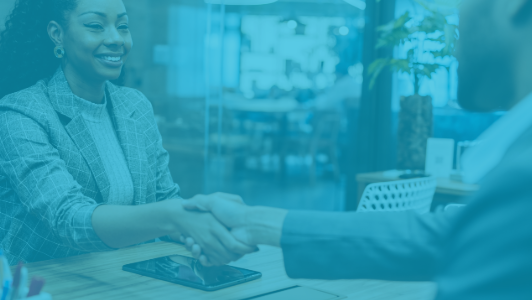 woman shaking hands with man in office with blue overlay