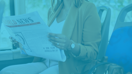 woman reading newspaper on bus with blue overlay