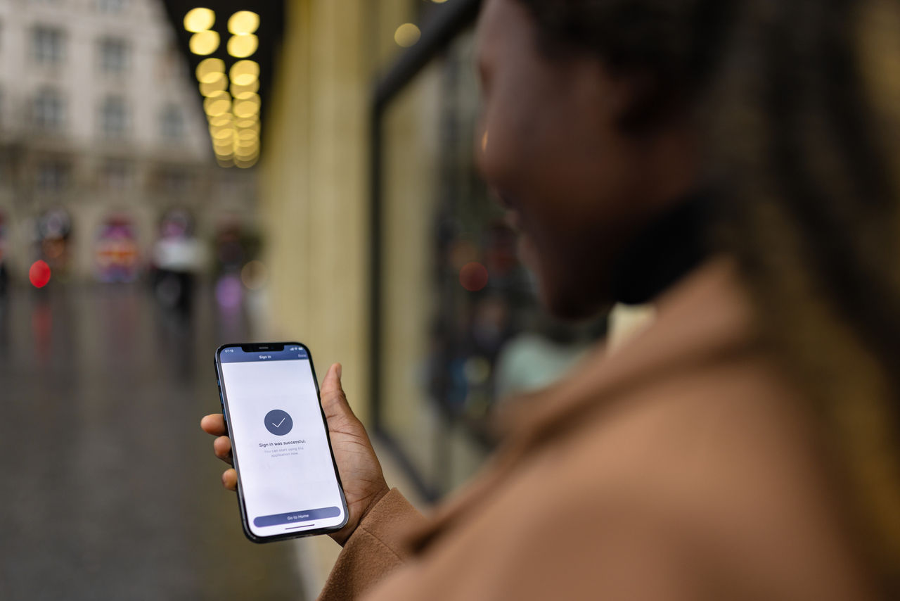 Black woman signing in to a mobile app