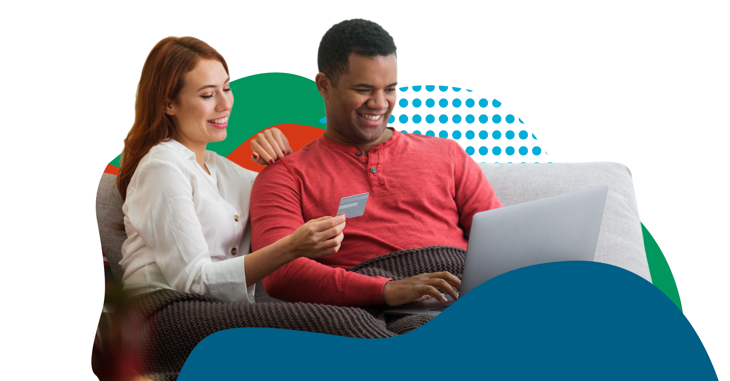 couple on couch shopping wtih credit card and laptop