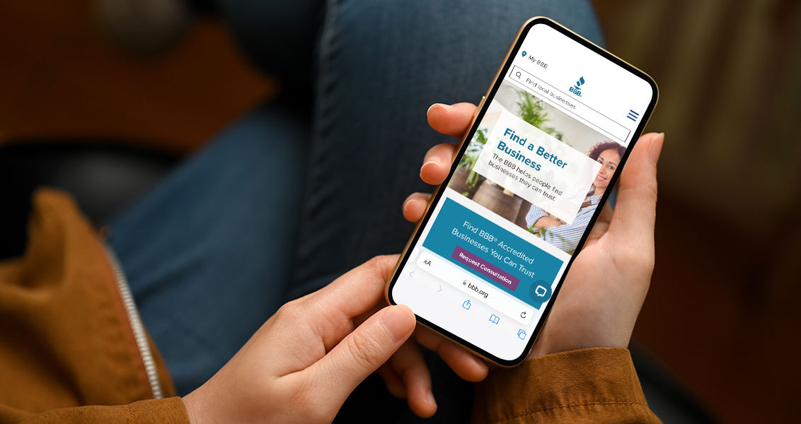Close-up, focus hands, Female in casual outfit, sits and relaxes at living room, using smartphone. phone white screen mockup.