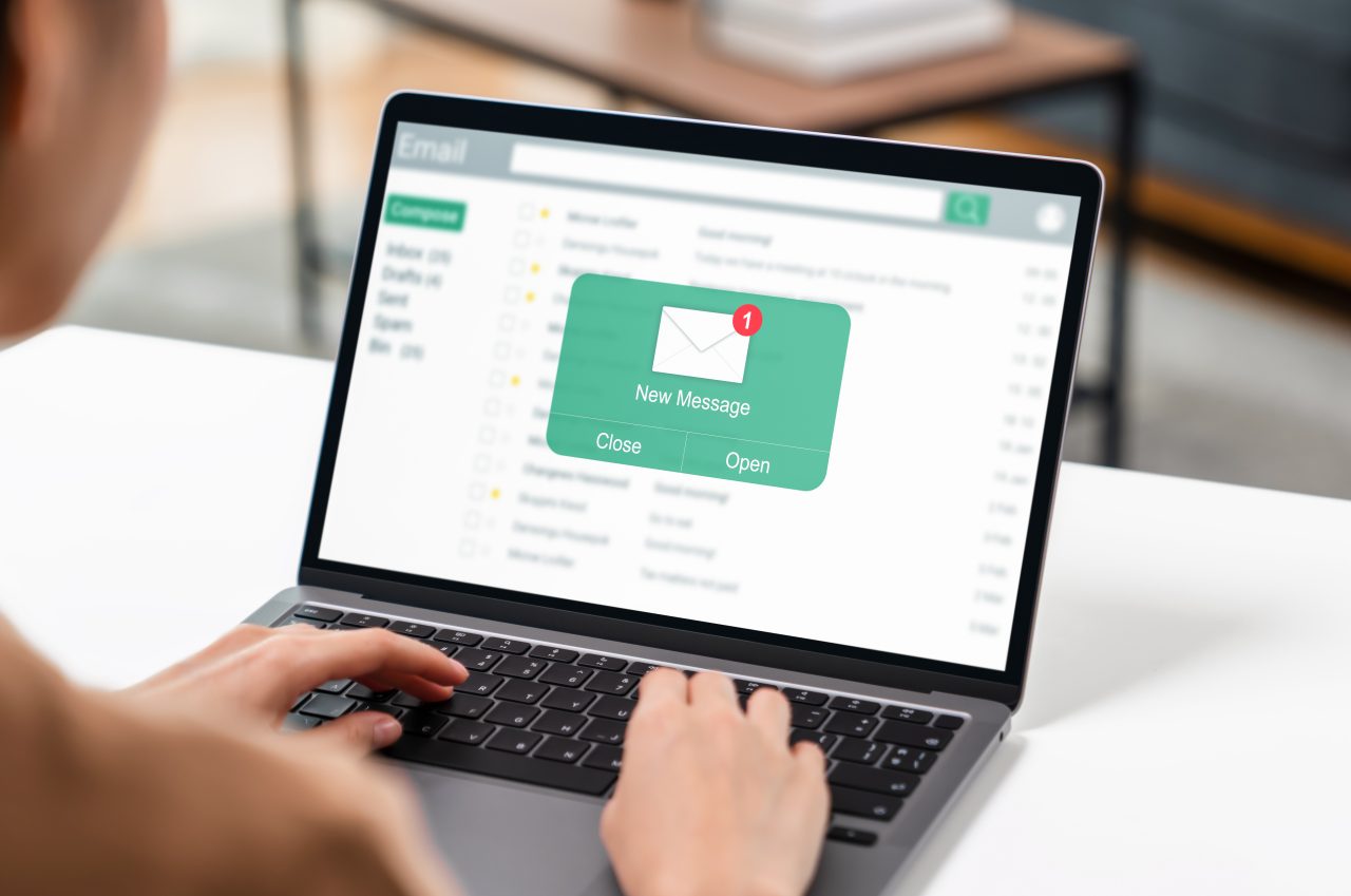 Woman using computer on table with new email message on laptop, communication connection message to global letters in the workplace