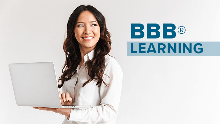 Woman smiling looking off to the side and holding a laptop with text "BBB Learning"