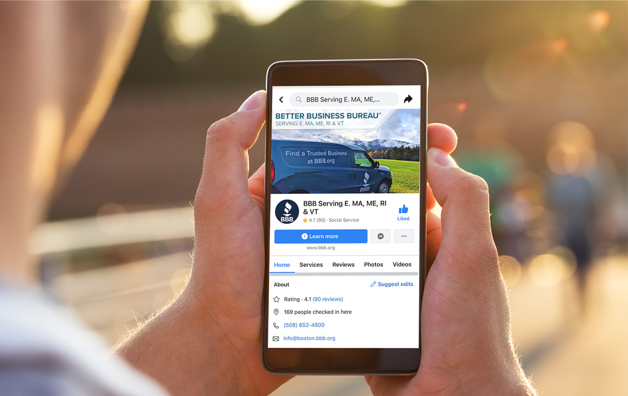 hands holding a cell phone with BBB Facebook feed showing.