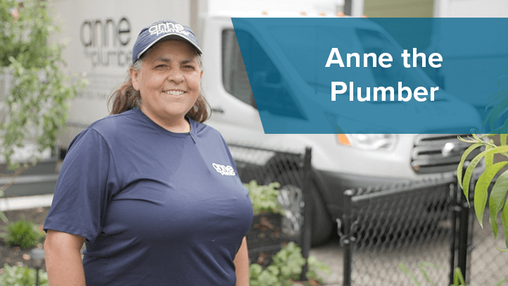 Anne the Plumber standing in front of work truck