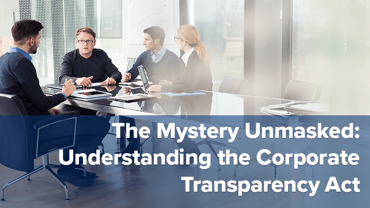4 people sitting at conference table with text "The Mystery Unmasked: Understanding the Corporate Transparency Act"