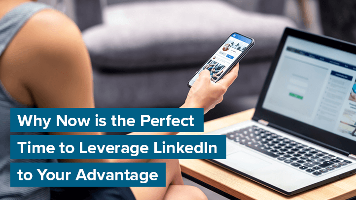 Person holding phone and looking at social media on laptop while sitting on couch with text "Why Now is the Perfect Time to Leverage LinkedIn to Your Advantage"