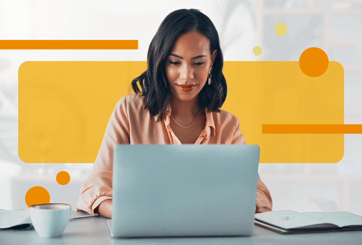 Woman checking email on laptop at desk