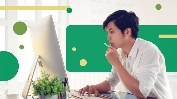 Man looking at computer monitor thinking