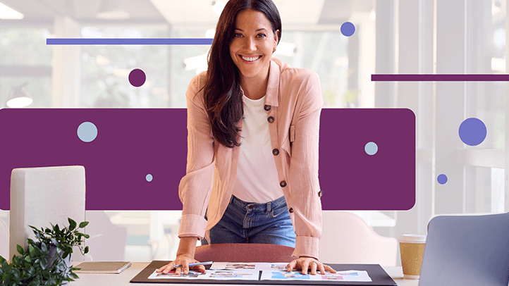 Woman standing behind desk approving advertising proofs