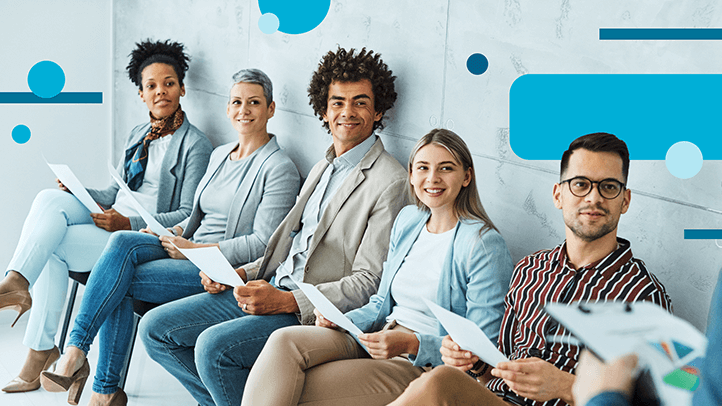Group of new employees sitting in chairs, holding paper and waiting