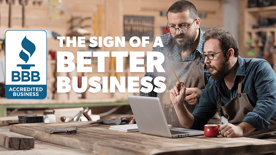 Sign of a Better Business with 2 males at a table