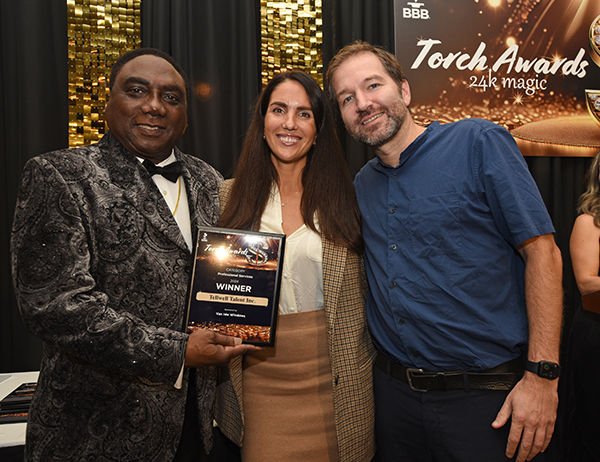 Tellwell Publishing owners getting photos with 2024 Torch Award plaque and BBB Board Chair