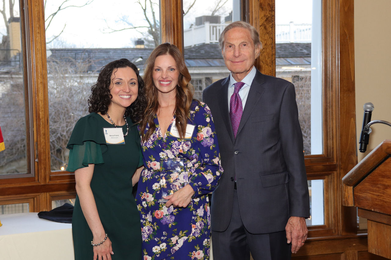 two women and a man posing for a picture