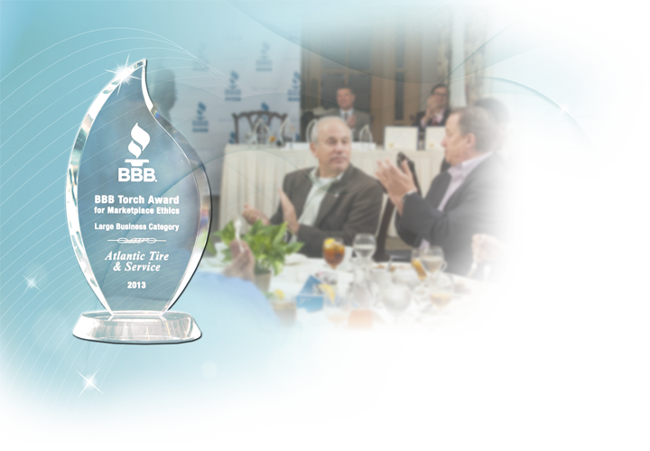 BBB torch award superimposed over photo of people at a business awards meal