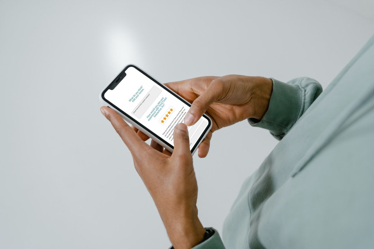 Man on his phone writing a review for a company