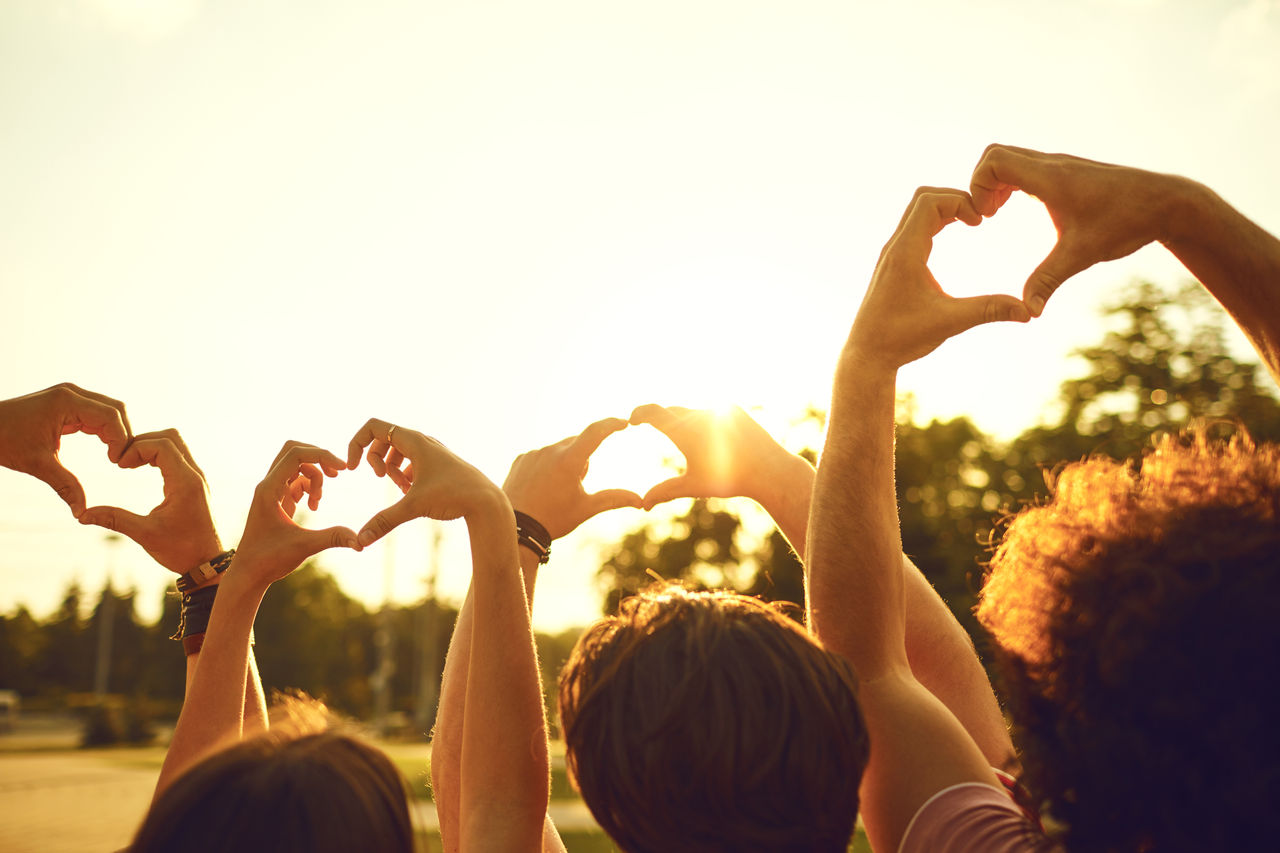 Group of people making hearts with their hands.