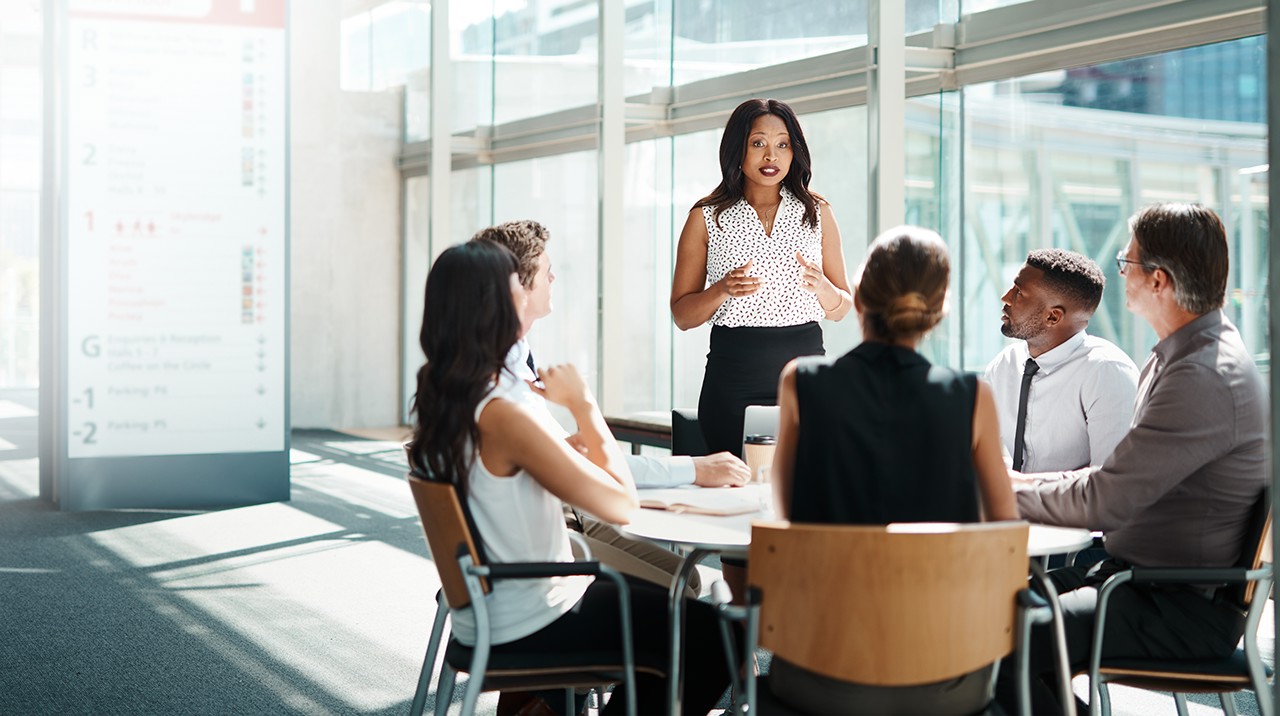 Woman speaking to office workers