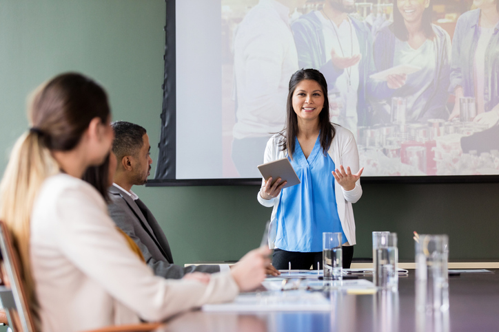 Woman giving presentation in front of a group