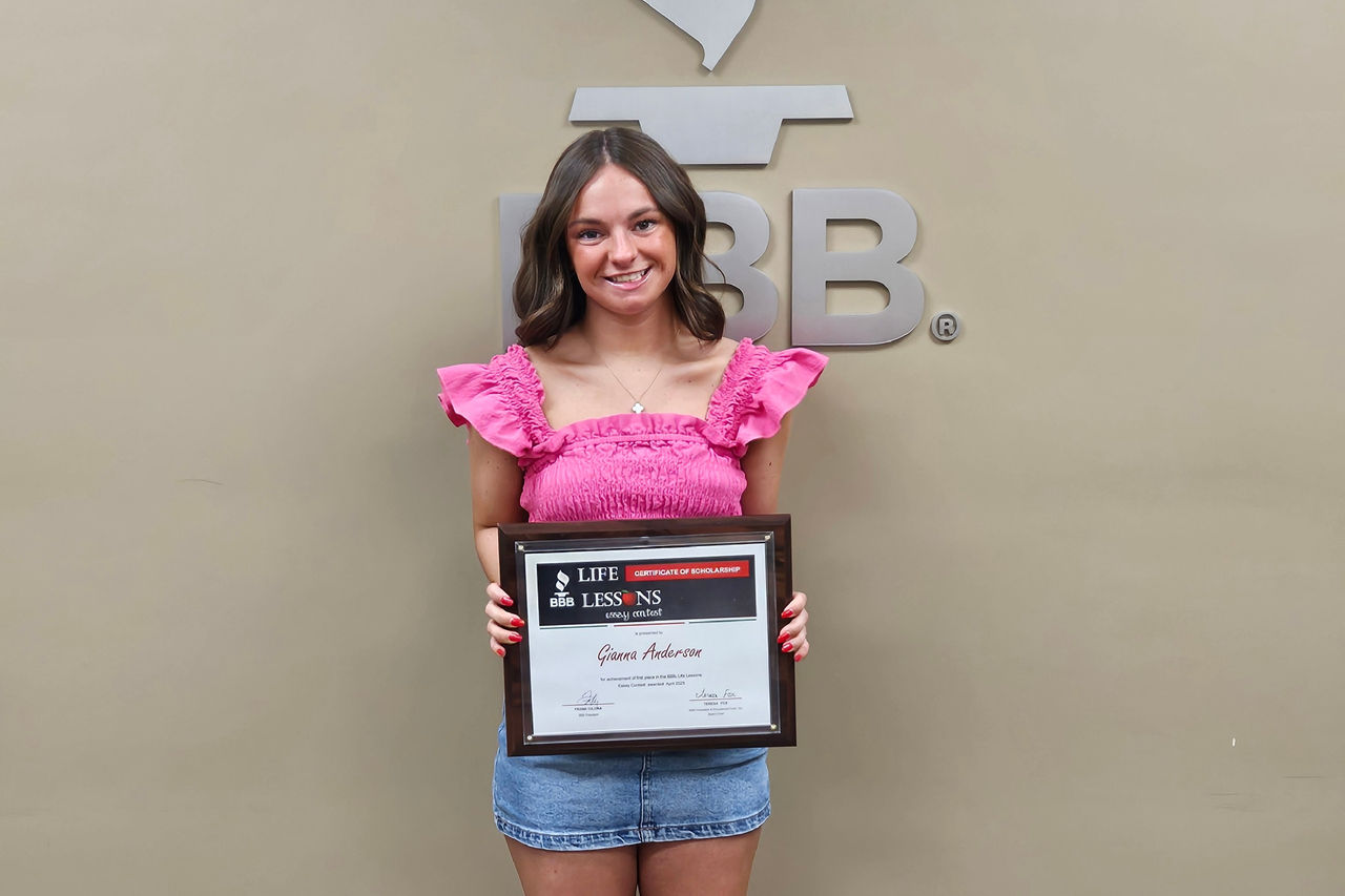 Gianna Anderson holding scholarship award certificate