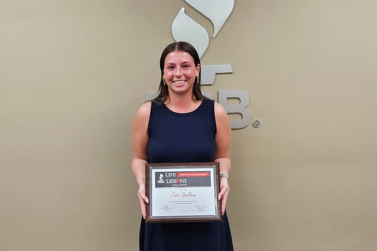 Josie Spellman holding scholarship award certificate