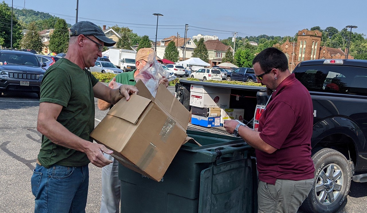 picture of volunteers dumping documents to be shredded