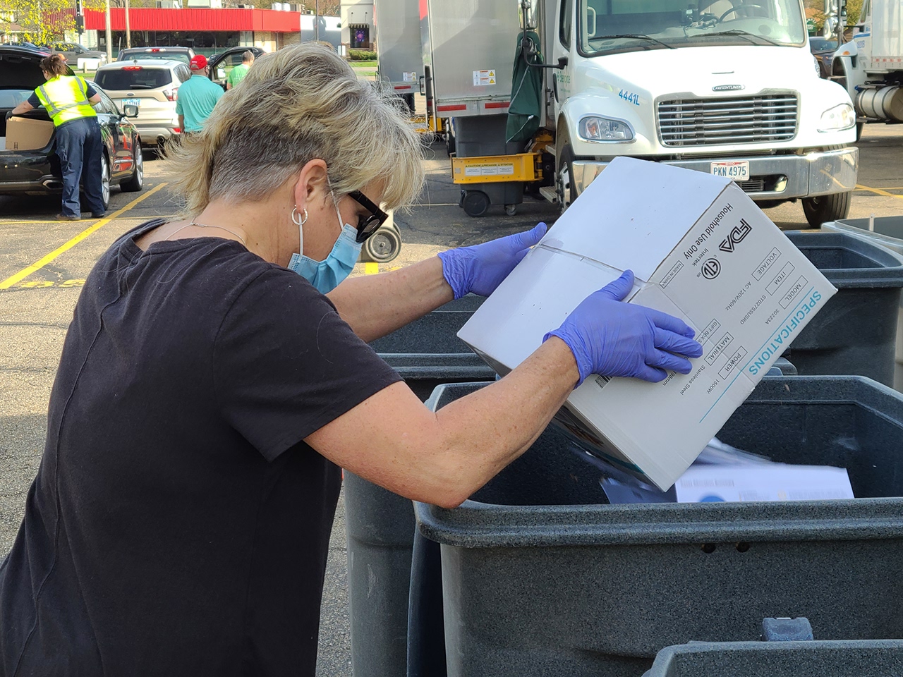 picture of volunteer dumping documents to be shredded