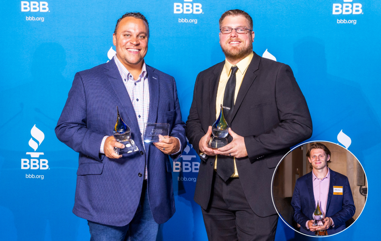 Two 2023 Spark Awards winners with trophies on a stage in front of a blue BBB backdrop with a small circle and headshot of one other winner in the bottom right corner.