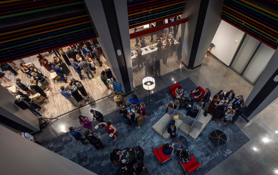 Overhead shot of awards gala guests enjoying hors d'oeuvres and drinks in the networking lounge.