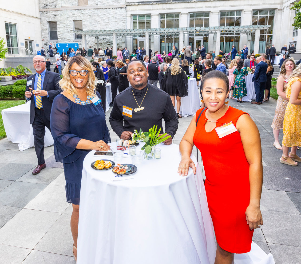 From left to right: BBB Board Member Kim Richards enjoying hors d'oeuvres in the courtyard with 2022 Spark Awards Winners and 2023 Spark Awards Judges Evan Johnson of Timeless Recording Studio and Aireal Ishola of Keystone Pediatric Therapy.