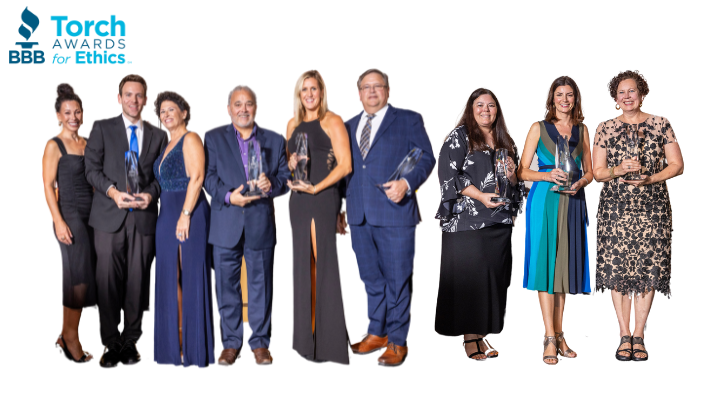 Nine 2024 Torch Awards for Ethics winners with trophies on a white background