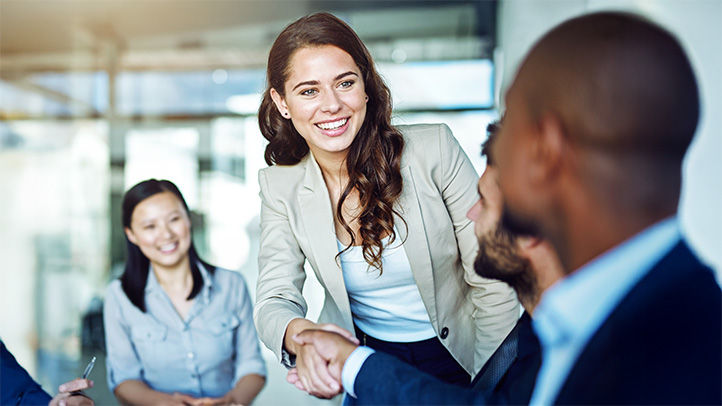 a woman shaking a man's hand