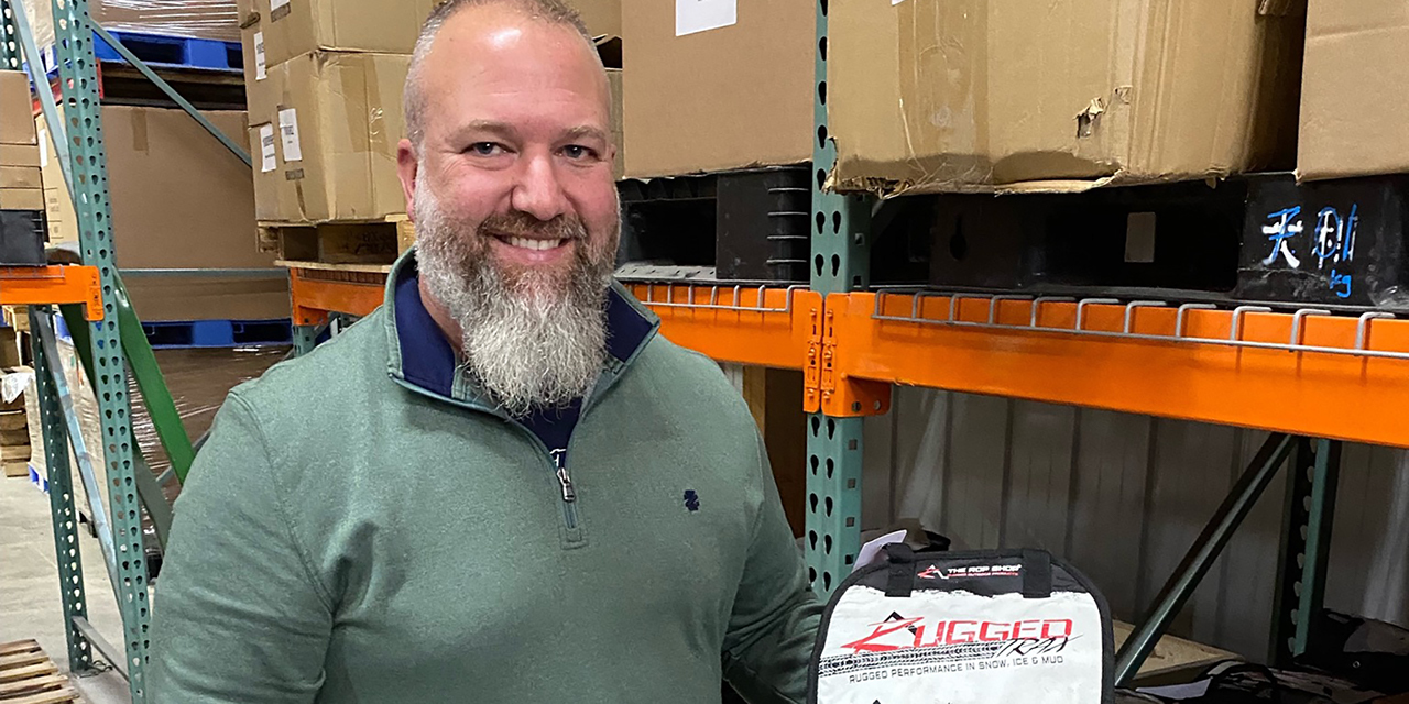 Man holding product in hand, smiling