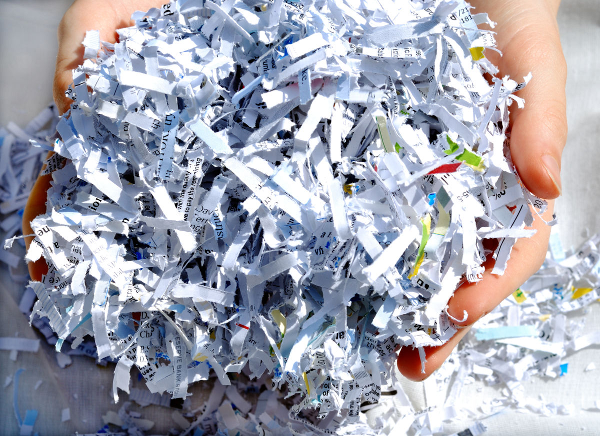 Hands holding shredded paper.