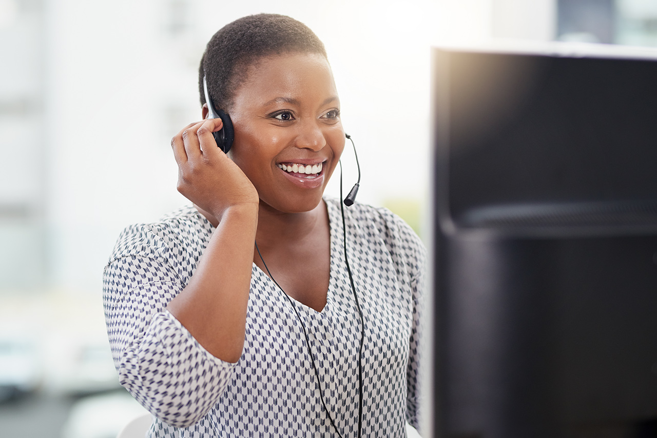 Shot of a call centre agent working on a computer in an office