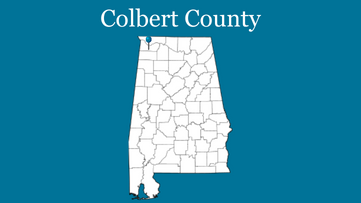 Blue background with outline of Alabama with blue pin on Colbert County and the words Colbert County up top