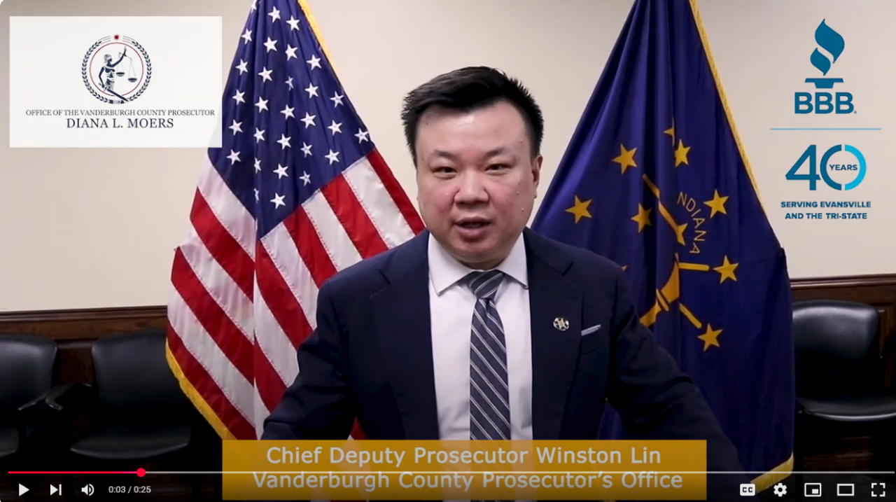 Photo of Chief Deputy Prosecutor Winston Lin from the Vanderburgh County Prosecutor's office standing with an Indiana flag