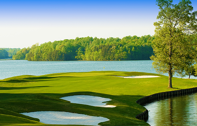 golf course hole with lake view and three sand traps