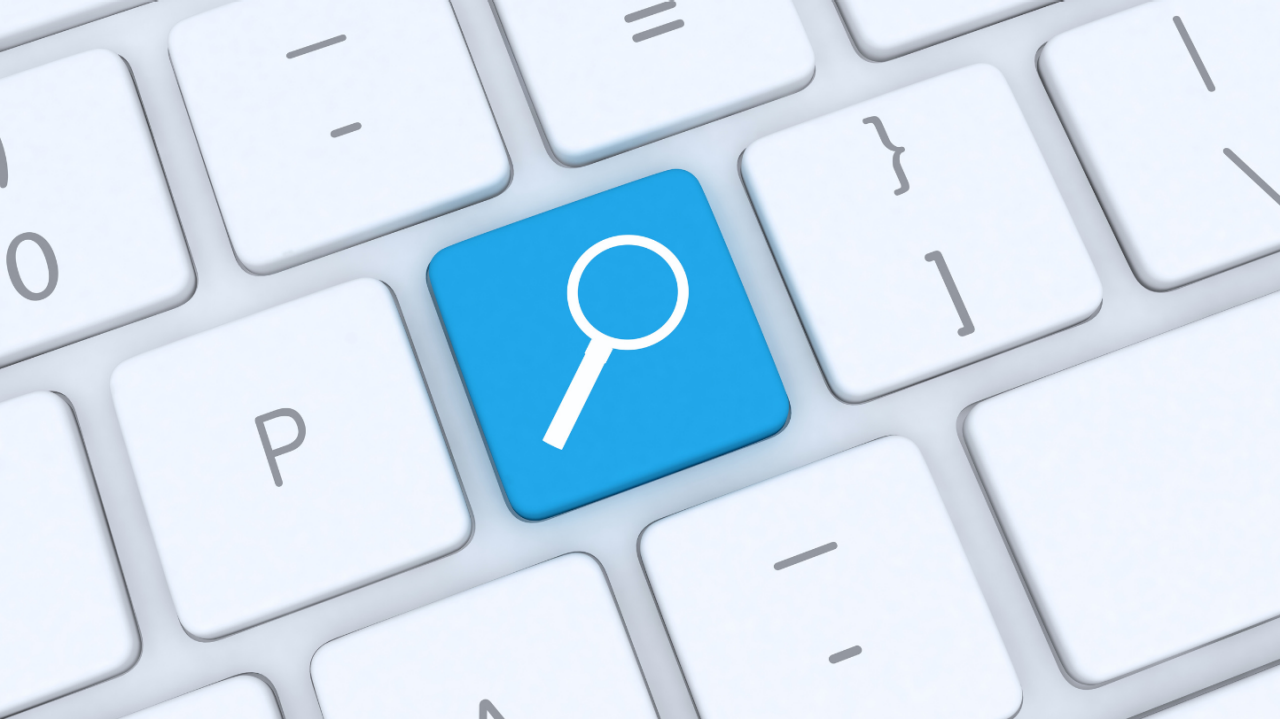 White keyboard with a blue search button