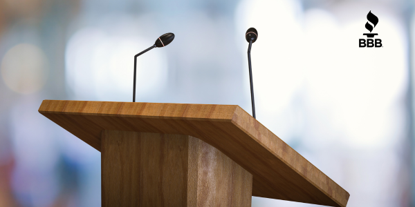 silhouette concert goers in front of green flashing lights