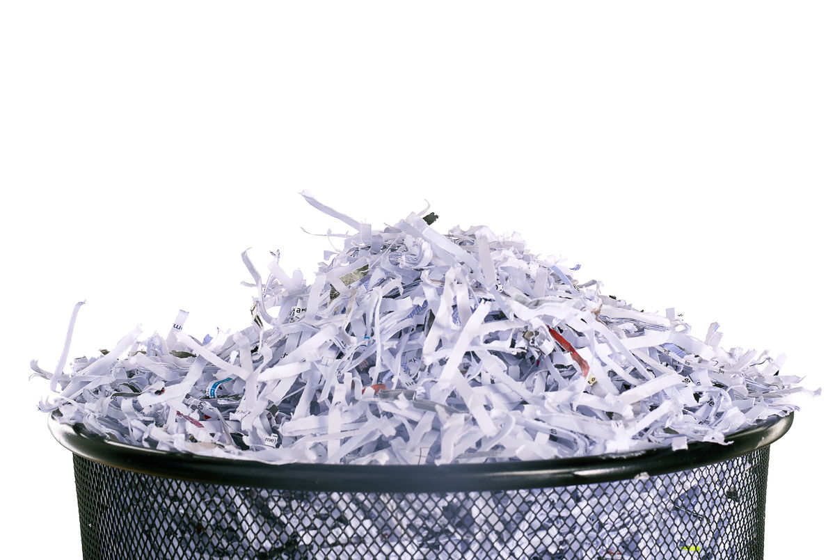 Studio shot of shredded paper in a dustbin against a white background