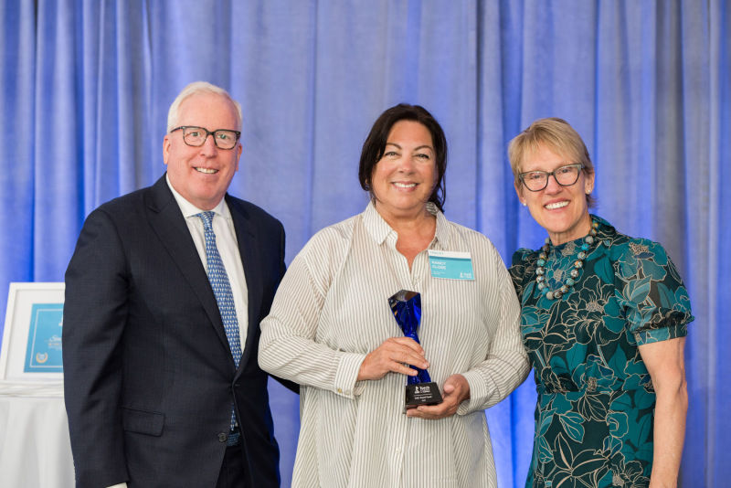 CFO of Preferred Credit, Inc. speaks on stage at podium of BBB Torch Awards for Ethics