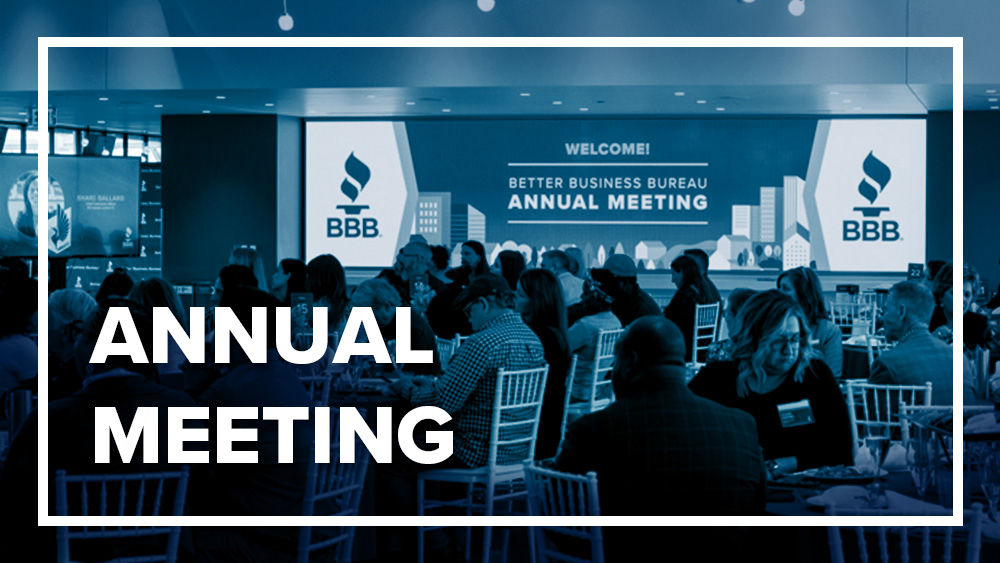 White text reading "Annual Meeting" inside blue box over blued image of people sitting at tables at event