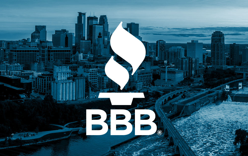 White BBB torch logo over blued image of Minneapolis skyline