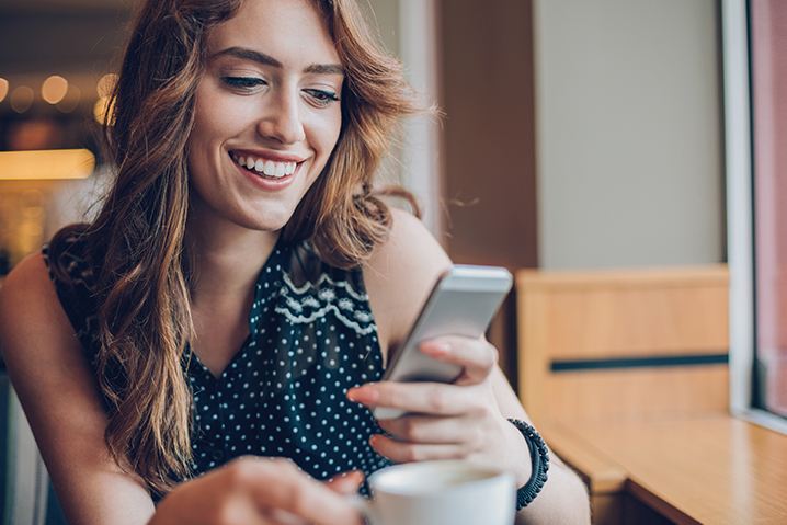 woman on iphone in cafe